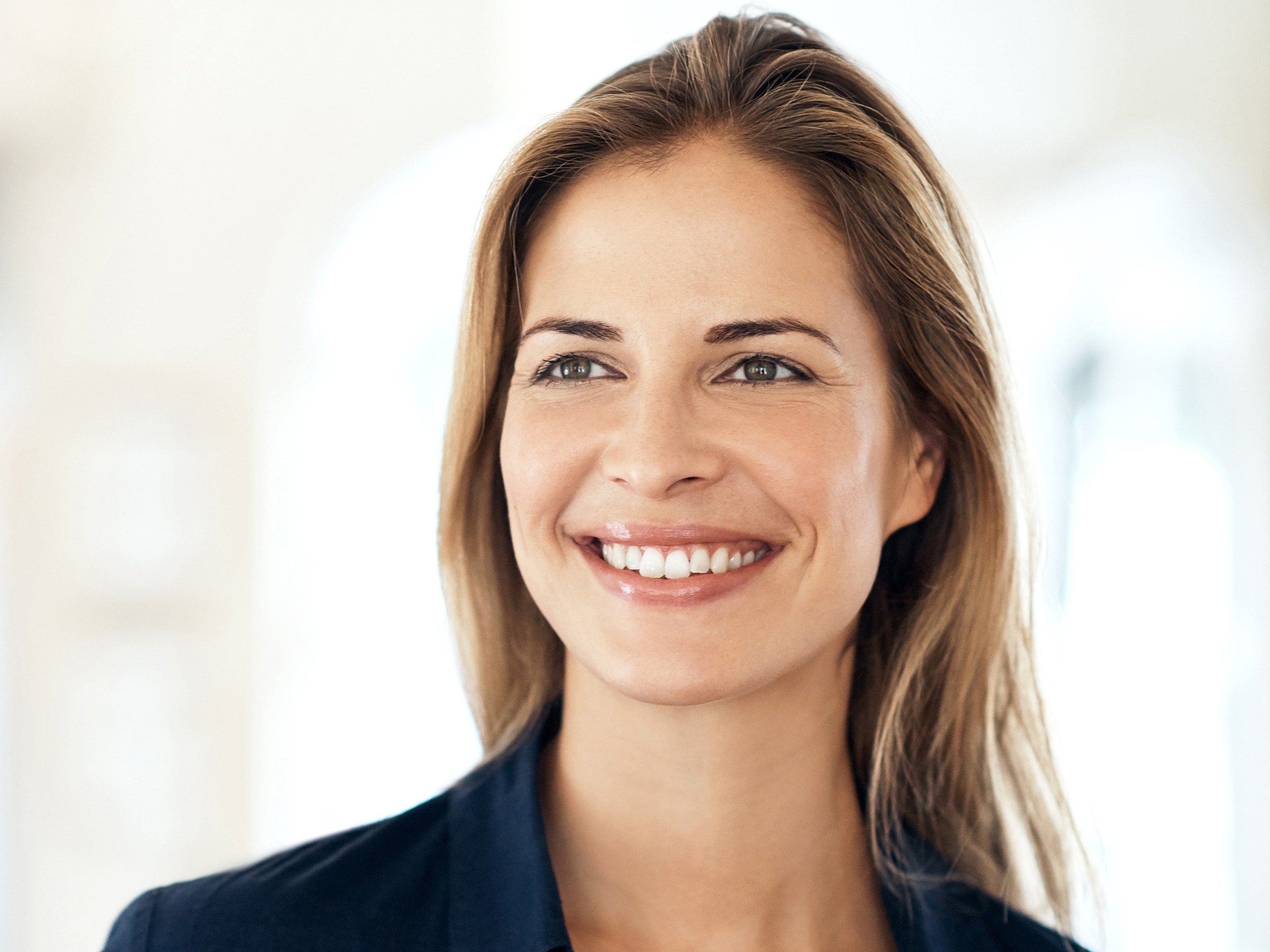 Smiling woman with long hair in bright setting