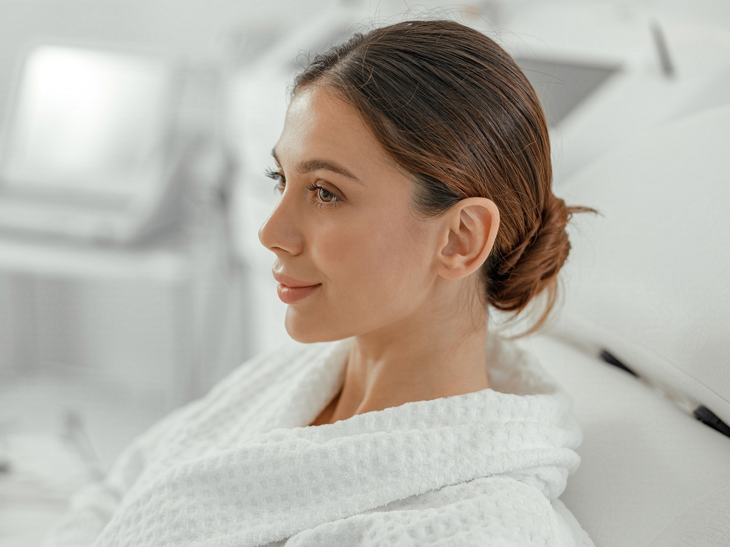 Woman in a robe relaxing at a spa.